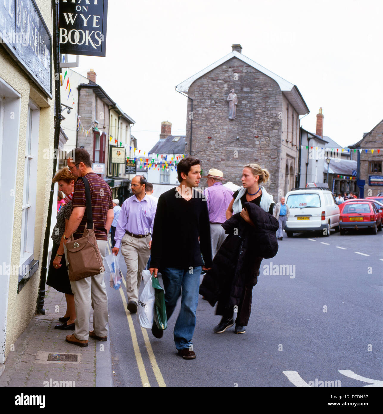 Visitors to Hay-on-Wye stroll past book shops during the Hay Festival of LIterature Wales UK  KATHY DEWITT Stock Photo