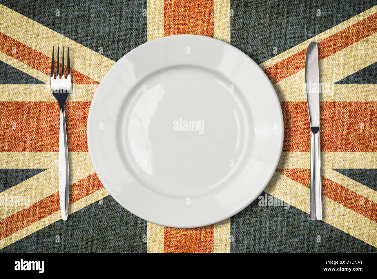 Plate, knife and fork over british flag canvas Stock Photo