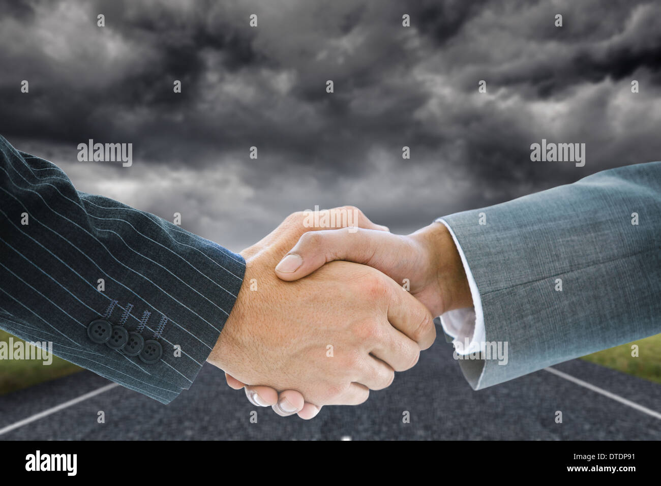Composite image of business handshake against storm Stock Photo