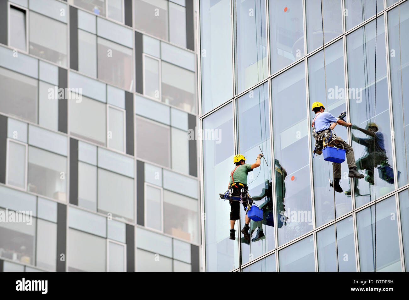 Window washers cleaning an office building exterior Stock Photo