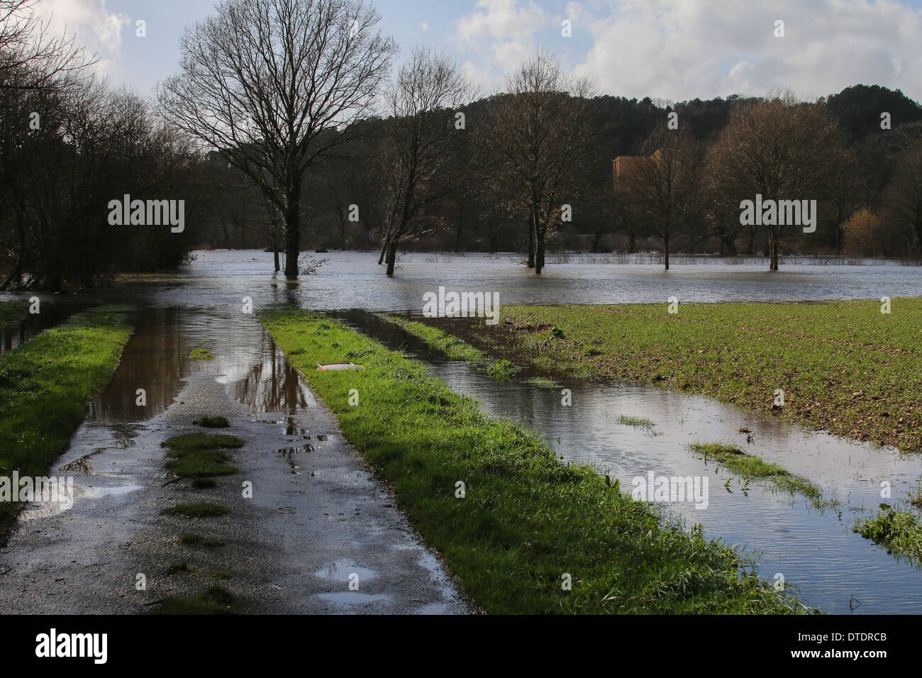 The Oust river in flood and road submerged, near St Laurent sur Oust, near Malestroit Stock Photo