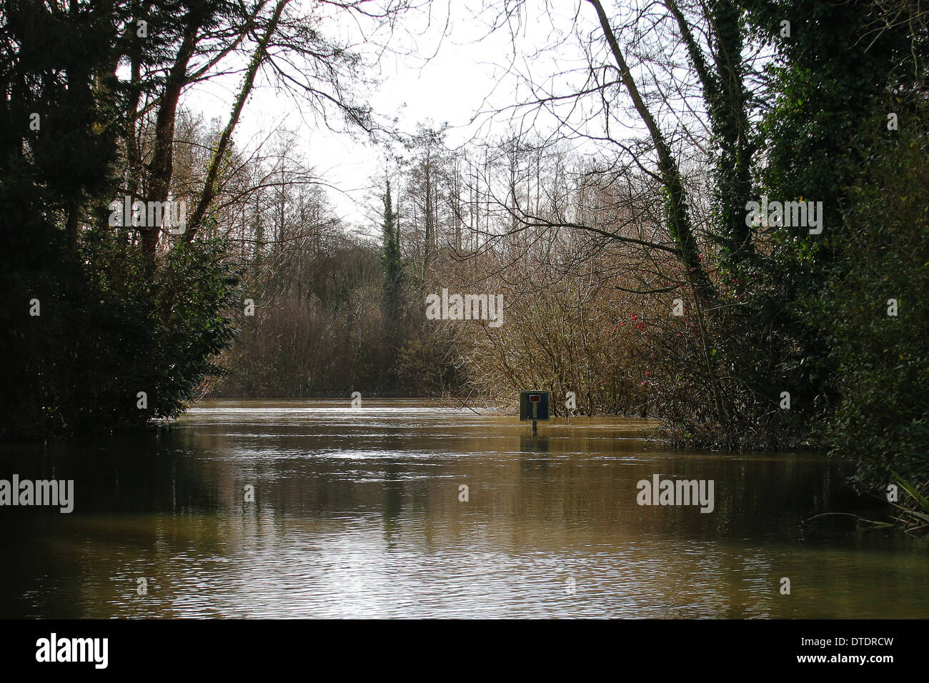 The Oust river in flood and road submerged, road sign, in St Laurent Sur Oust Stock Photo