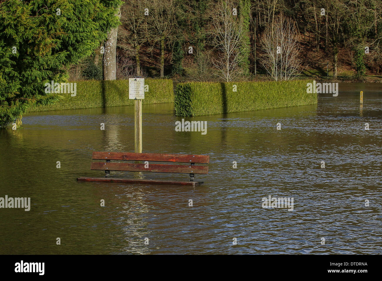 Submerged bench in a public garden in St Congard Stock Photo