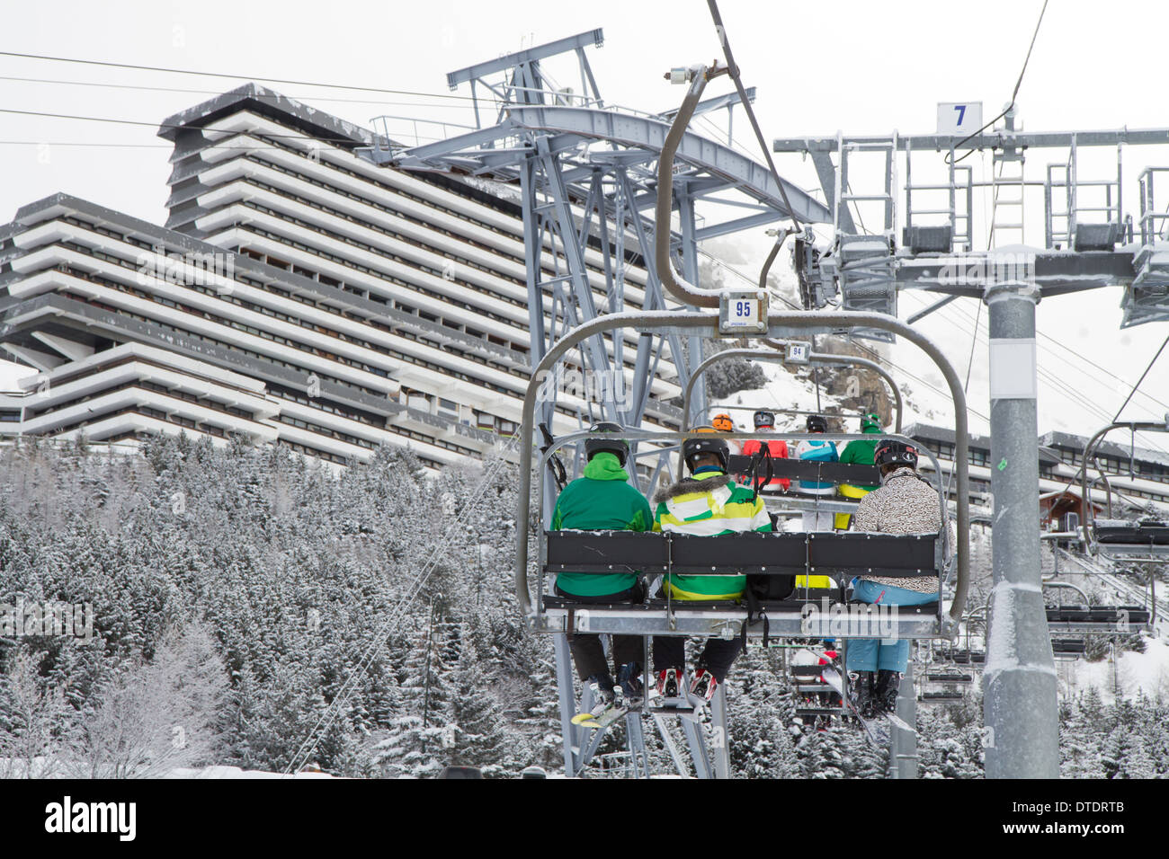 Skiers in a chairlift in Les Menuires, Trois Vallees, France Stock Photo