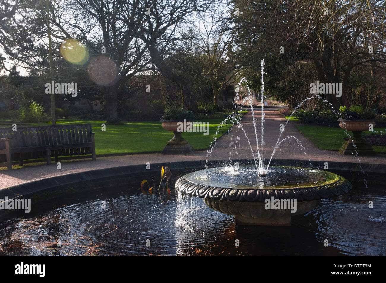 Fountain in the Oxford Botanic / Botanical Gardens in the winter sunshine (with flare). UK. Stock Photo