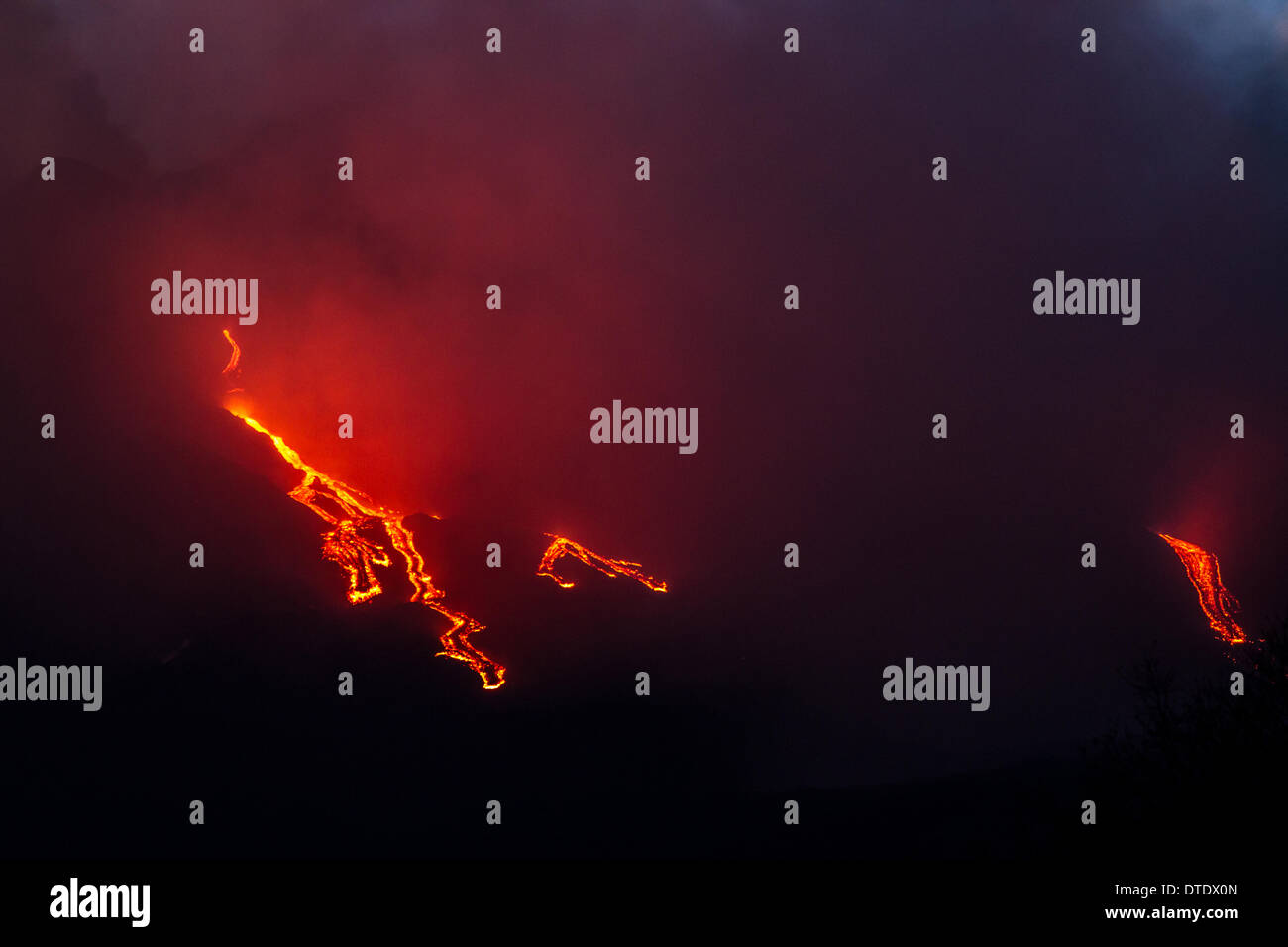 More explosions in the night and lava flow Stock Photo