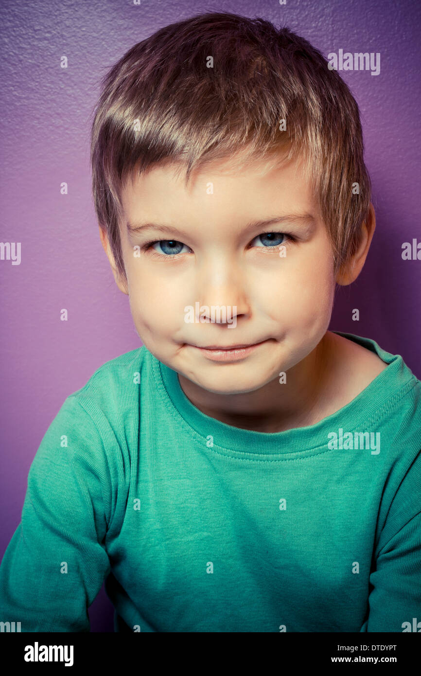 Young boy indoors looking at camera Stock Photo - Alamy