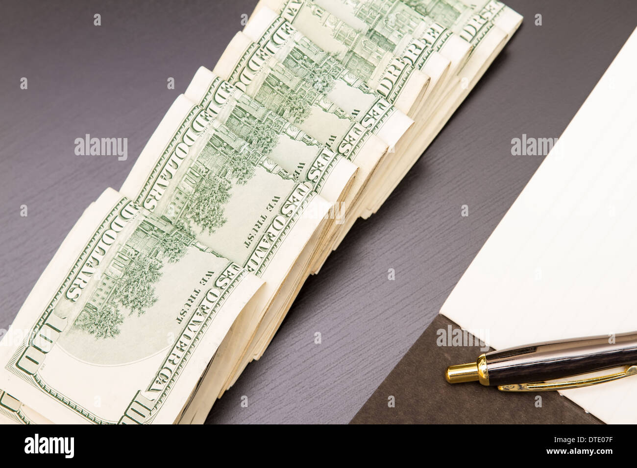 Lots of dollars with an open copybook Stock Photo