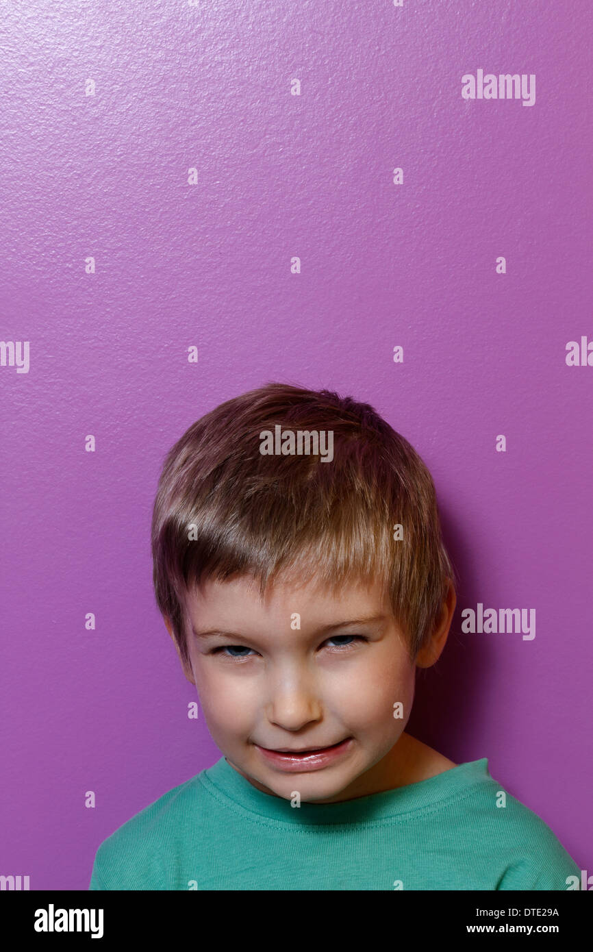 Young boy indoors looking at camera Stock Photo - Alamy