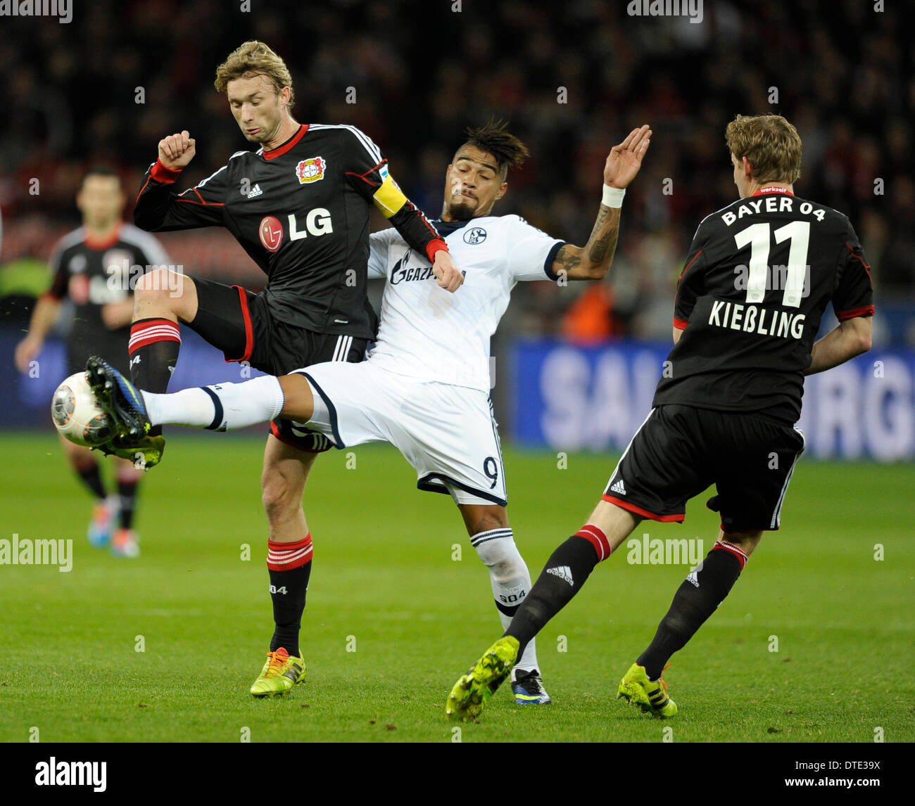 BayArena Leverkusen Germany ,15th February .2014, Football Bundesliga Season 2013/14, matchday 21, Bayer 04 Leverkusen  - Schalke 04 1:2  ---  Kevin-Prince Boateng (S04,m.) between Simon Rolfes (Leverkusen,li.) and Stefan Kie§ling (Kiessling) (Leverkusen) Stock Photo