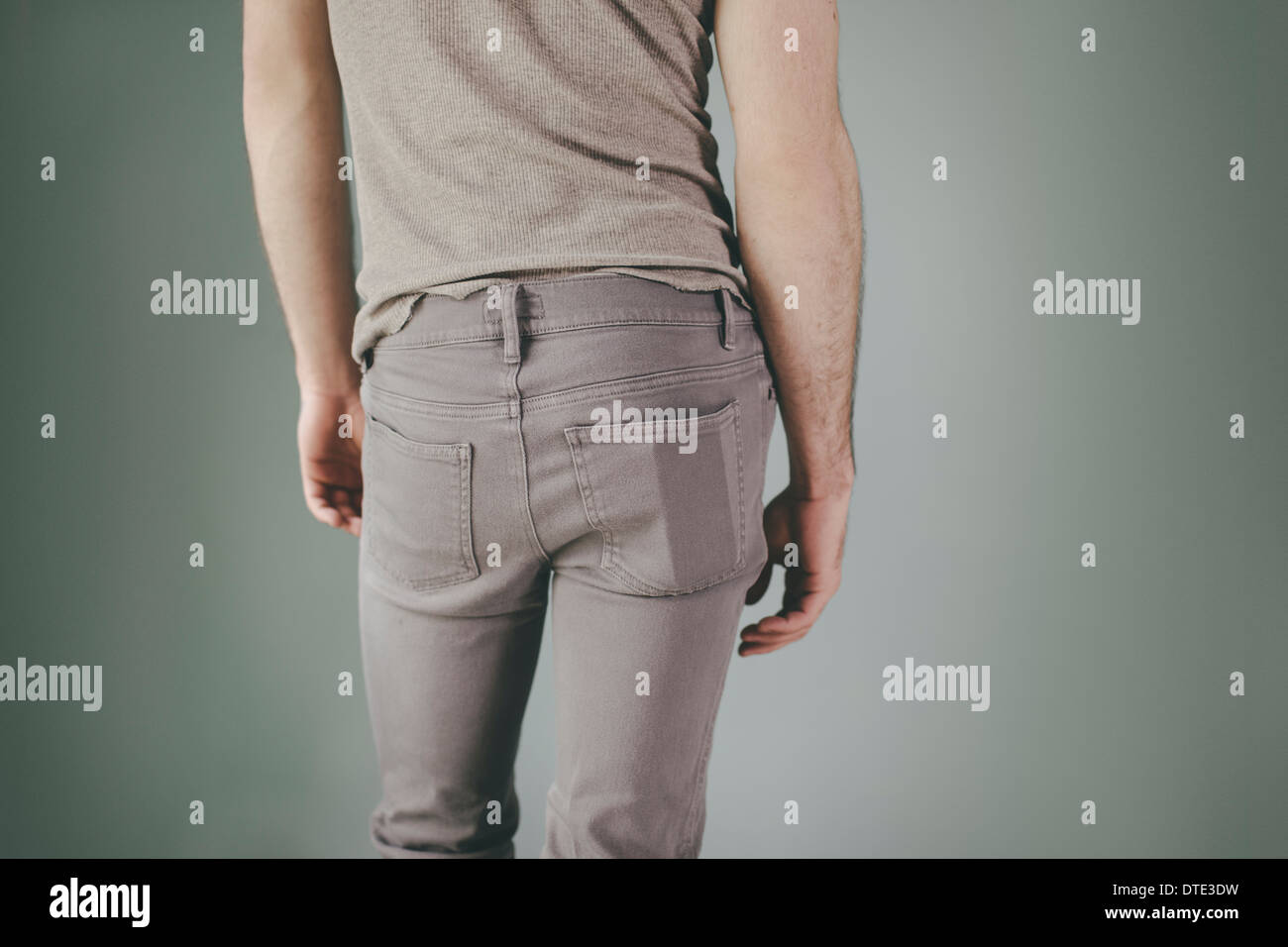 Part of series showing different ways one carries a smartphone, in the back pocket of tight jeans Stock Photo