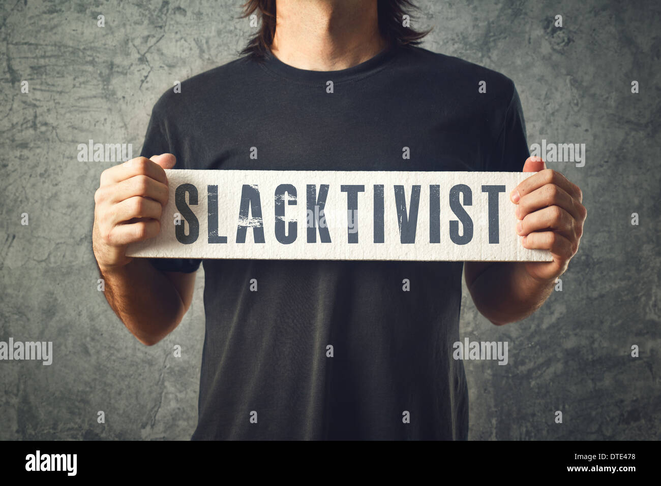 Man holding white banner with SLACTIVIST title, conceptual image Stock Photo