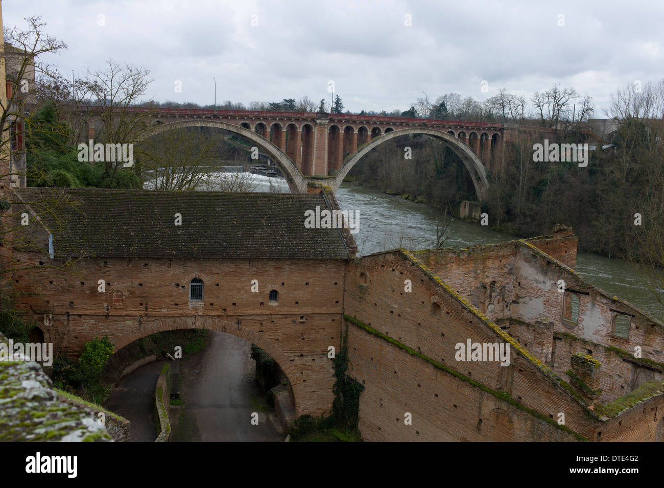 The arched bridge at Rabastens, a town on the Tarn river, in the department of Tarn, Occitanie, France in winter Stock Photo