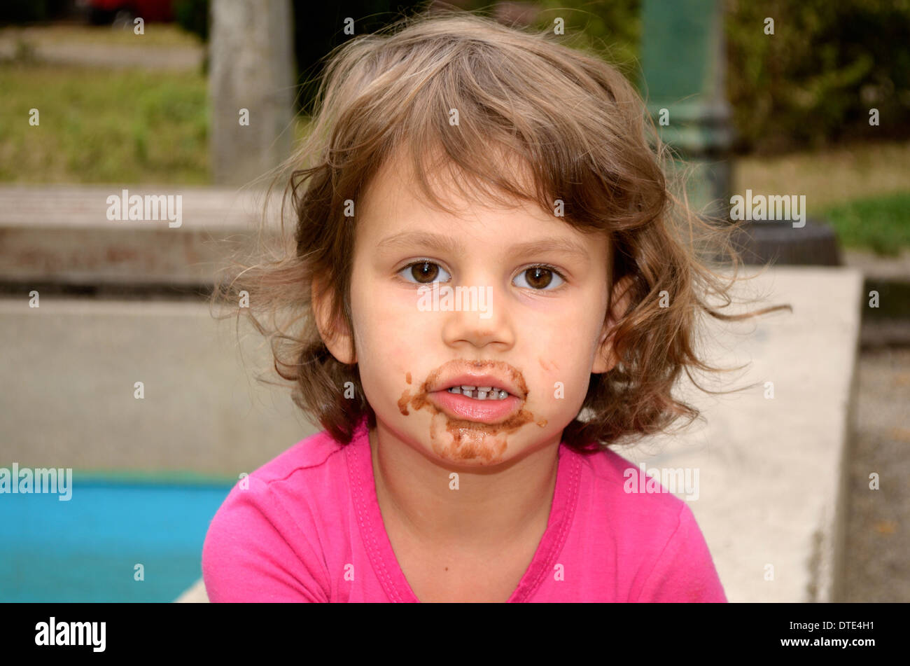 4 year old girl smudged from licking ice cream Stock Photo