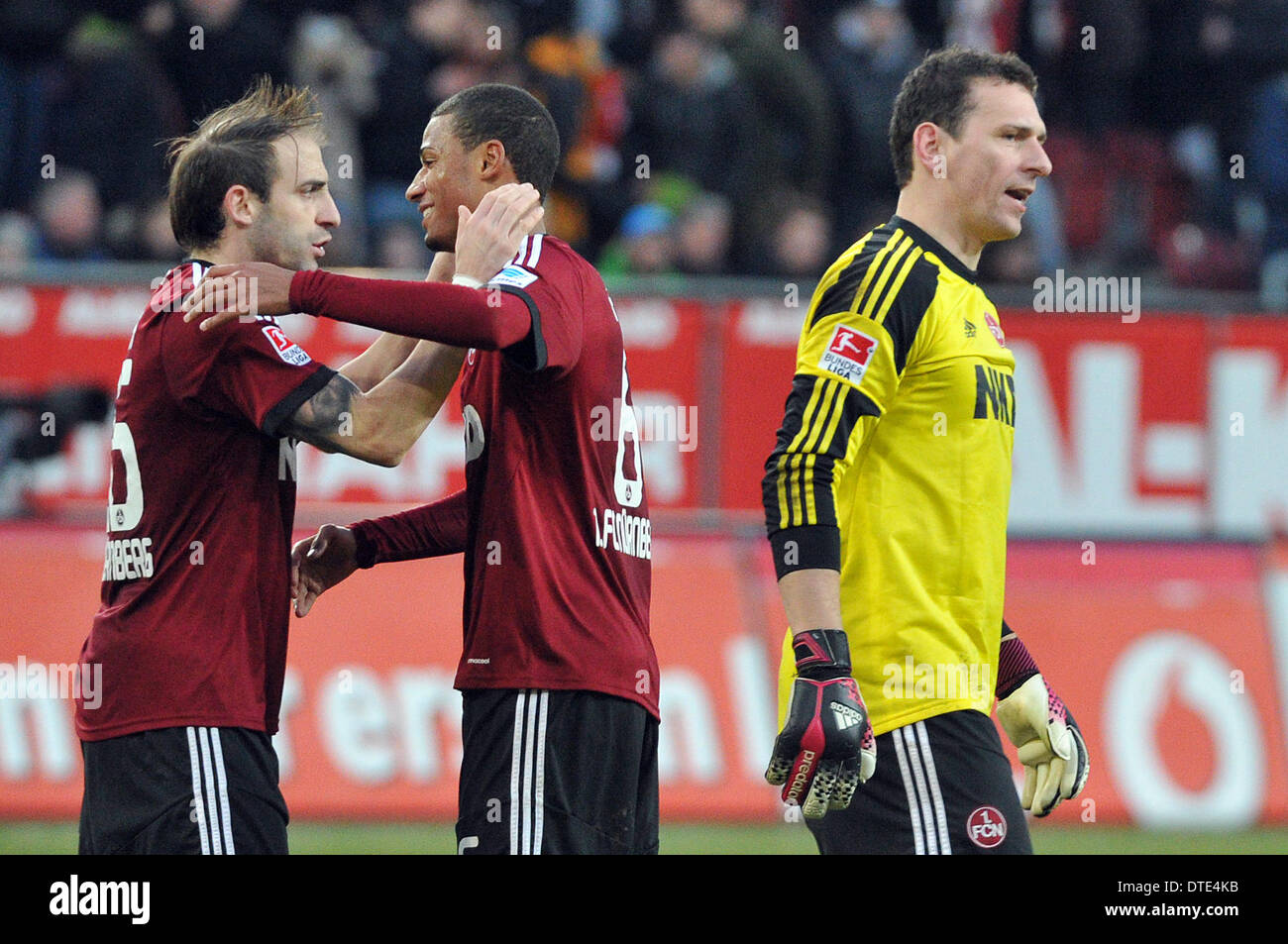 Augsburg, Germany. 16th Feb, 2014. Nuremberg's Javier Pinola (L-R), Martin Angha and goalkeeper Raphael Schaefer celebrate the 1-0 victory in the German Bundesliga match between FC Augsburg and 1.FC Nuremberg at SGL-Arena in Augsburg, Germany, 16 February 2014. Photo: STEFAN PUCHNER/dpa (ATTENTION: Due to the accreditation guidelines, the DFL only permits the publication and utilisation of up to 15 pictures per match on the internet and in online media during the match.)/dpa/Alamy Live News Stock Photo