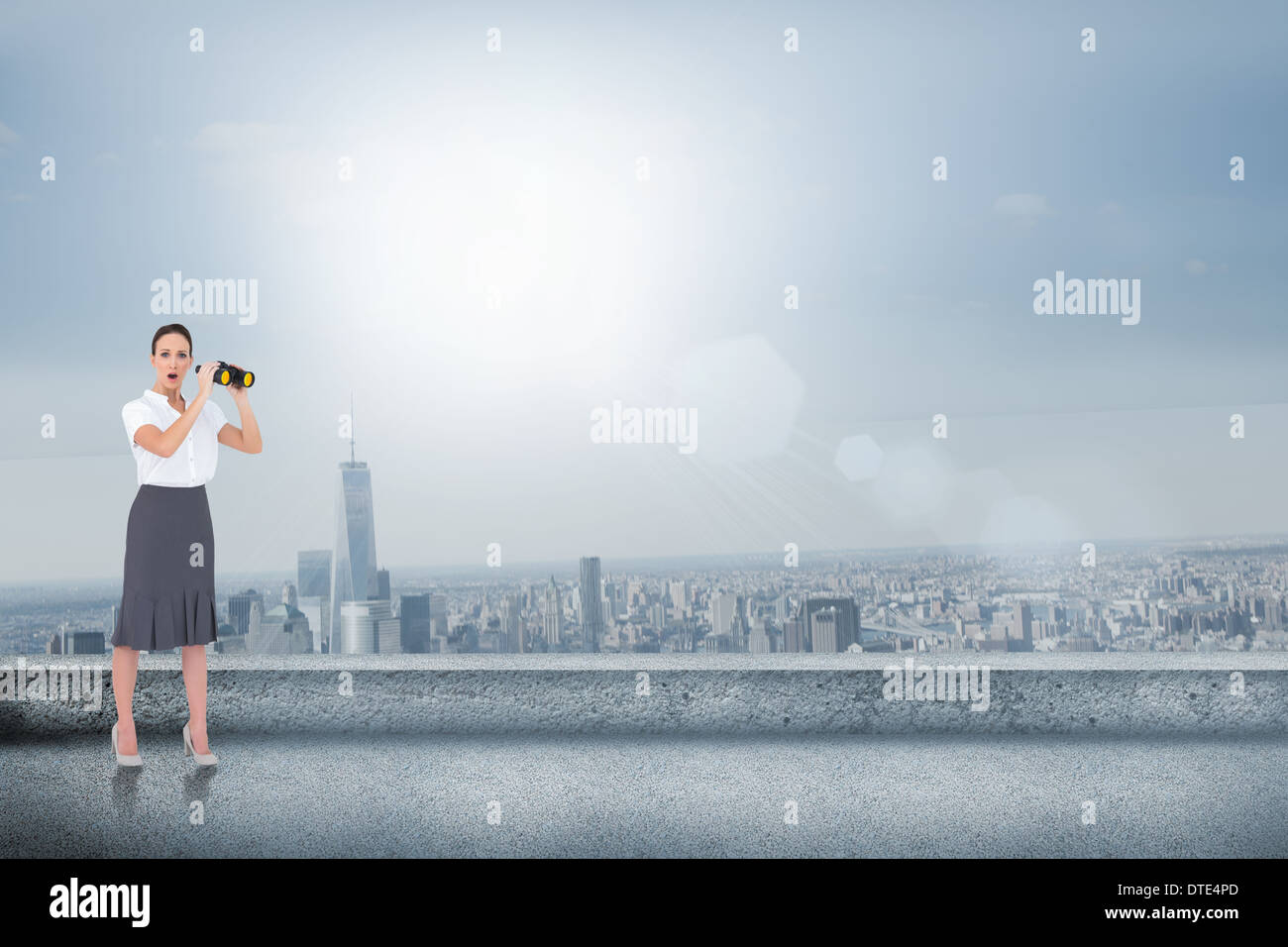 Composite image of astonished elegant businesswoman holding binoculars Stock Photo