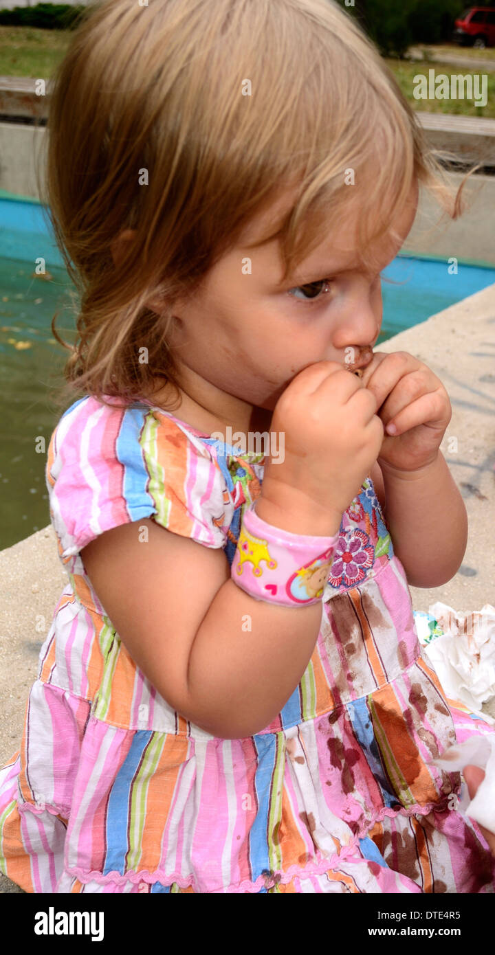 2 year old girl smudged from licking ice cream Stock Photo