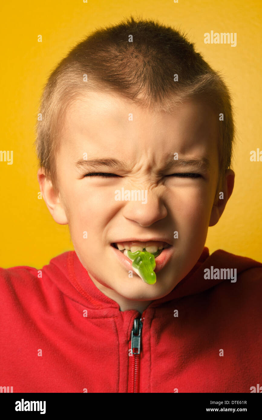 Portrait of boy (6-7) eating candy. Stock Photo