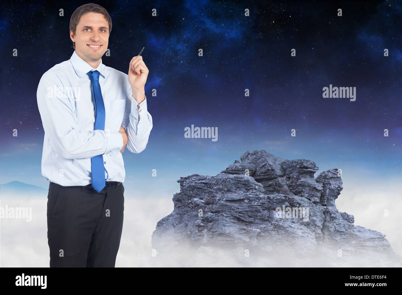 Composite image of thinking businessman holding pen Stock Photo - Alamy