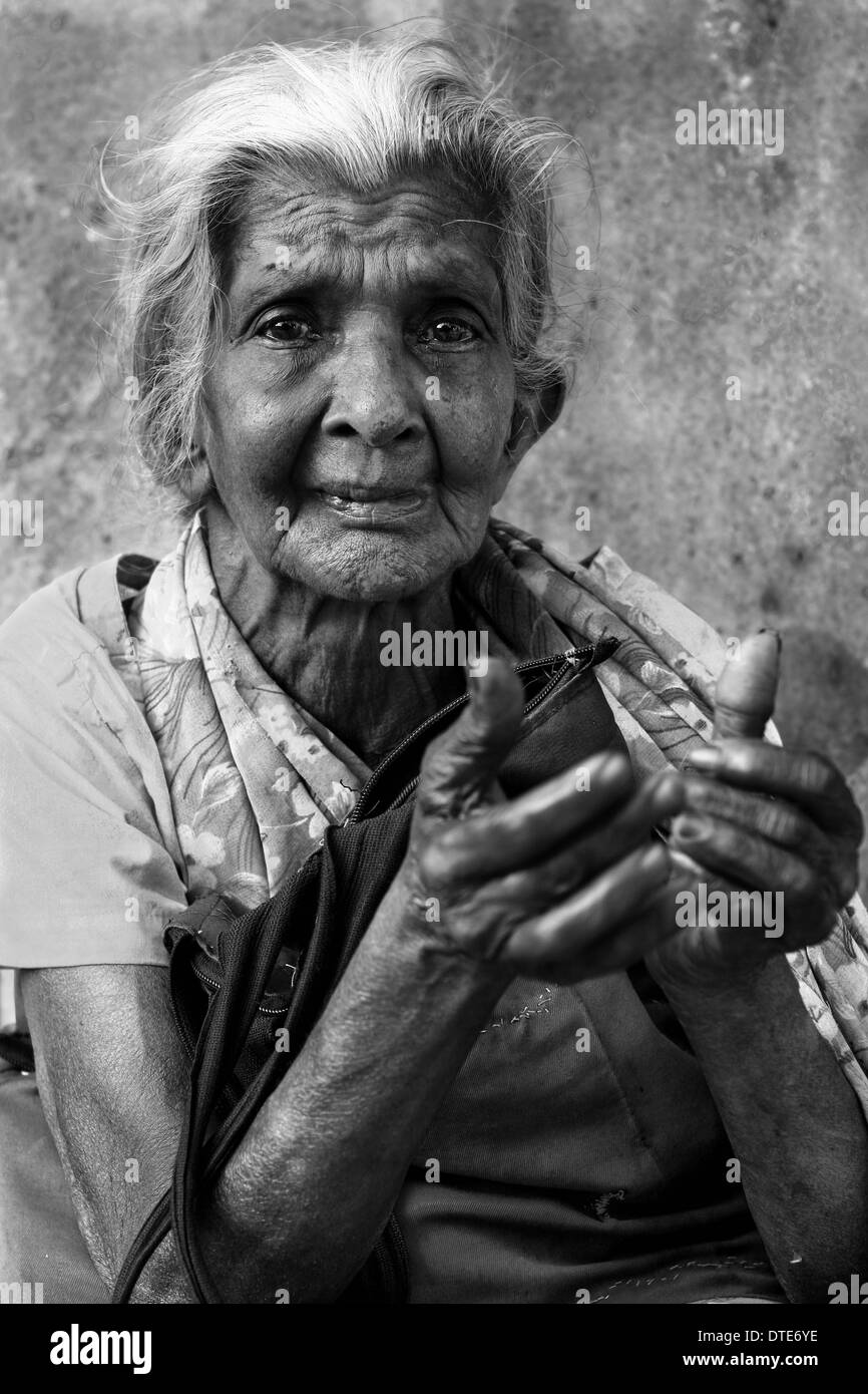 Old lady looking desperately at the camera. Stock Photo