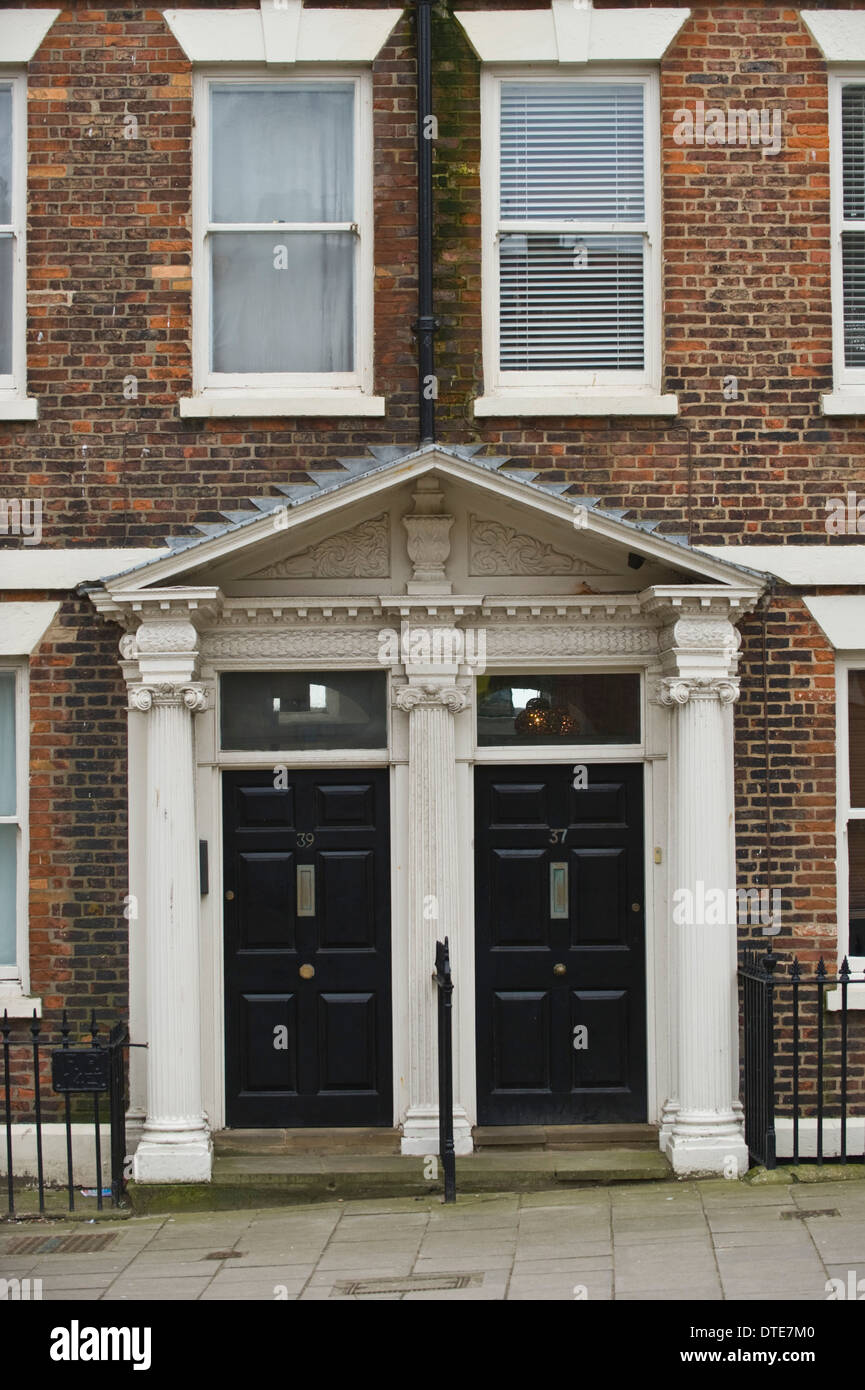 Black number 39 & 37 wooden front doors of houses in Scarborough North