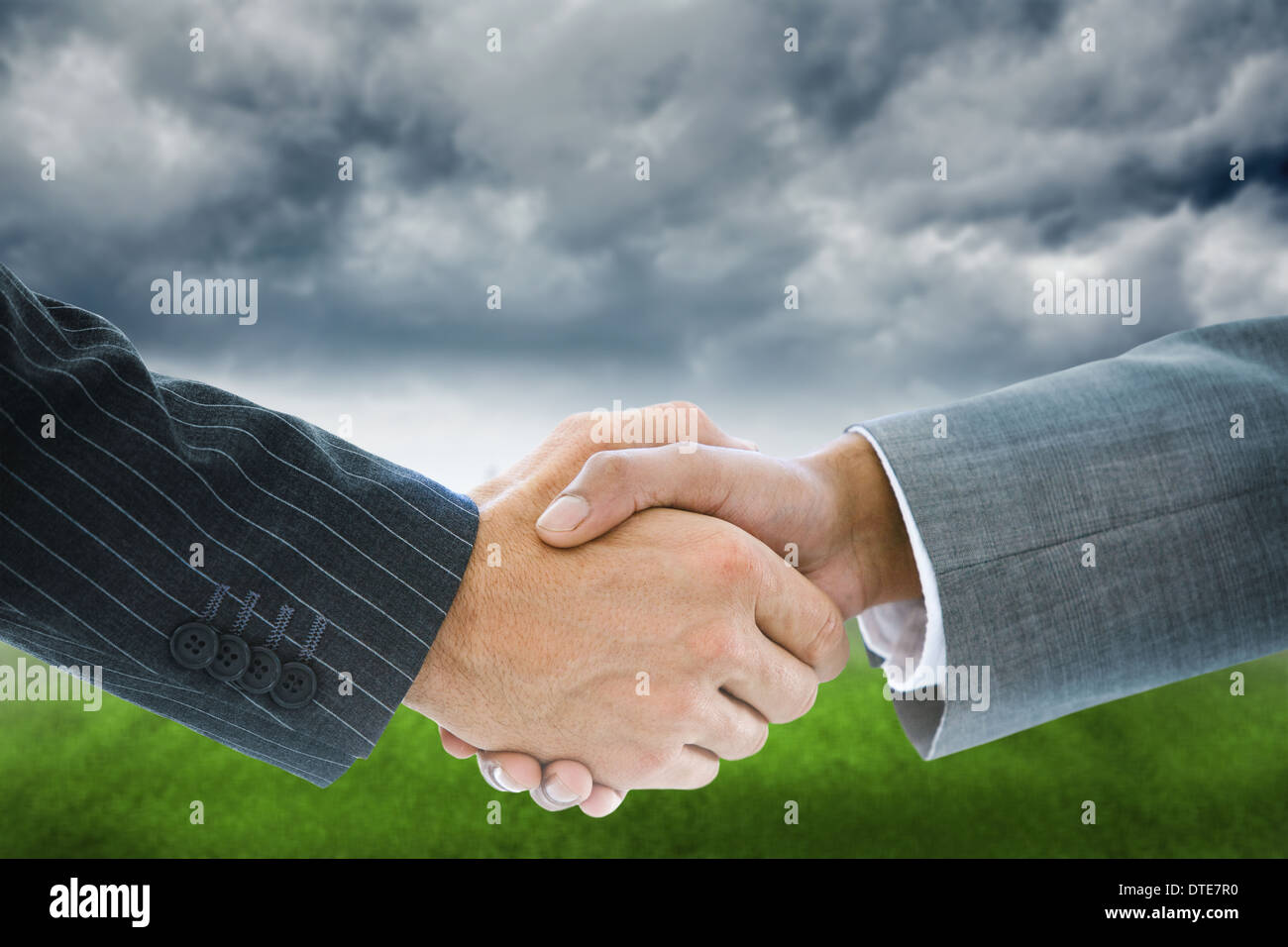 Composite image of business handshake Stock Photo - Alamy