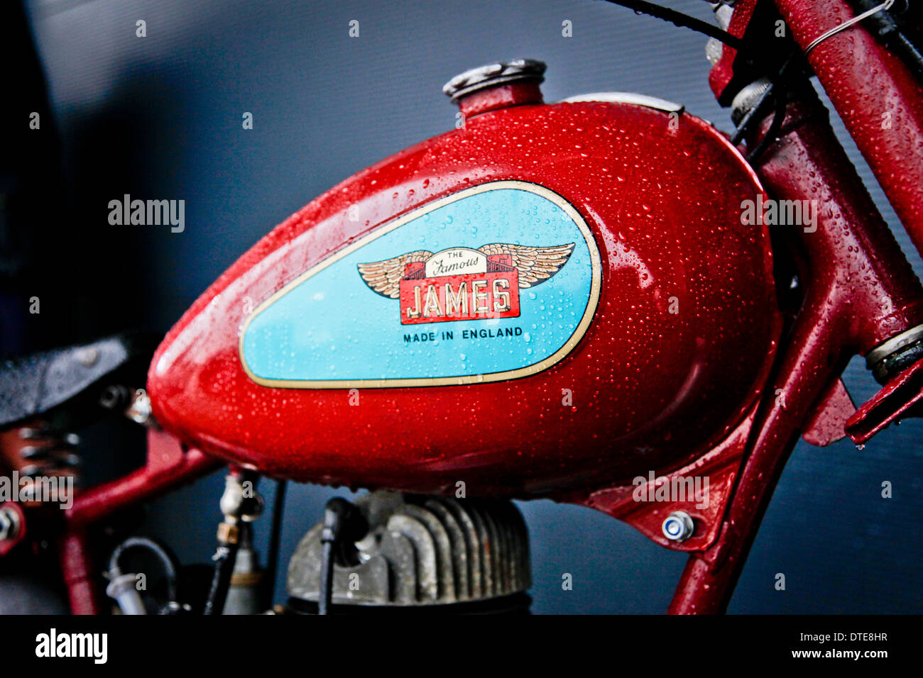 A vintage James motorcycle fuel tank with rain dripping down the Stock