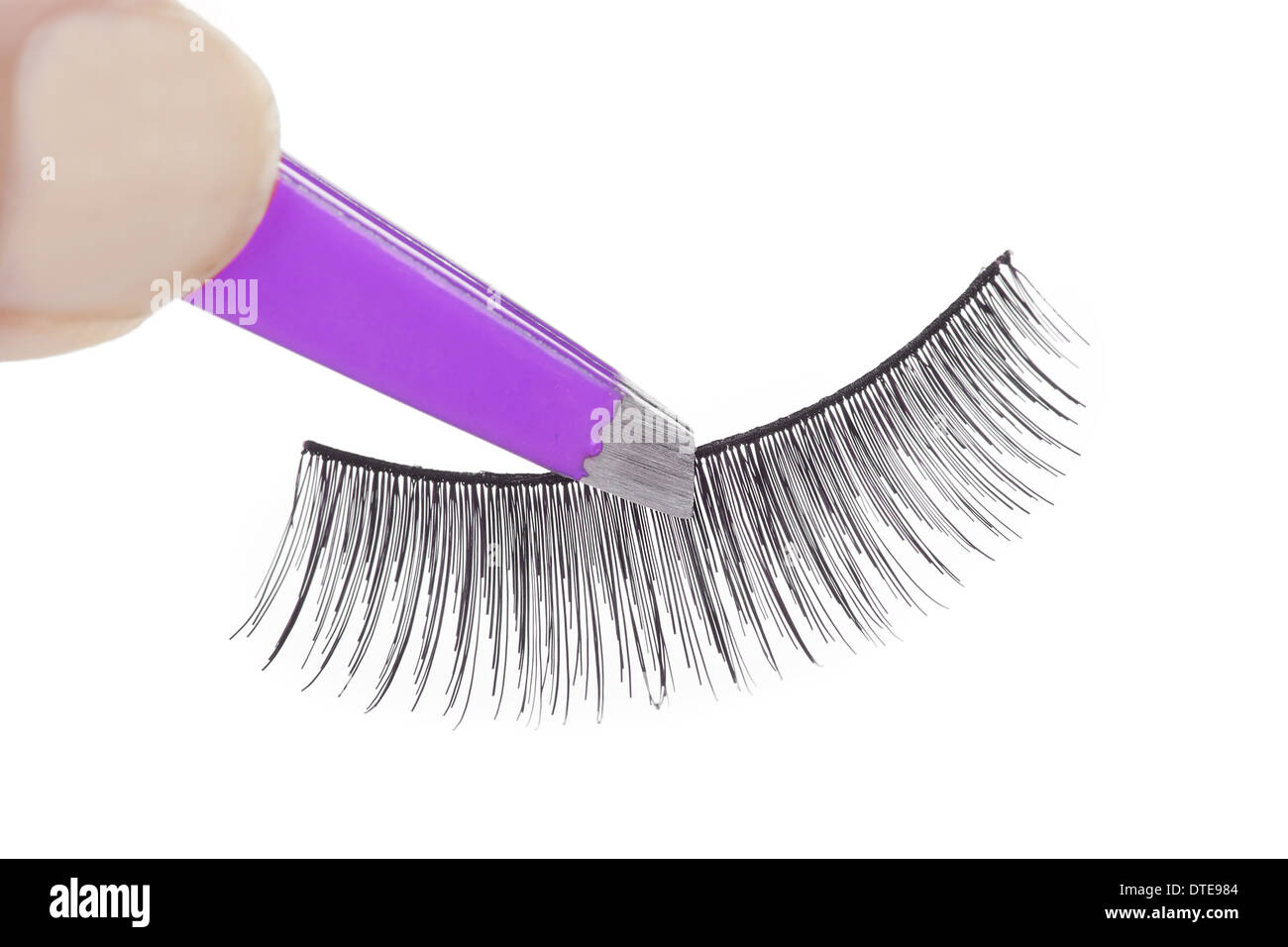 False lashes and pink pincers, closeup on white background  Stock Photo