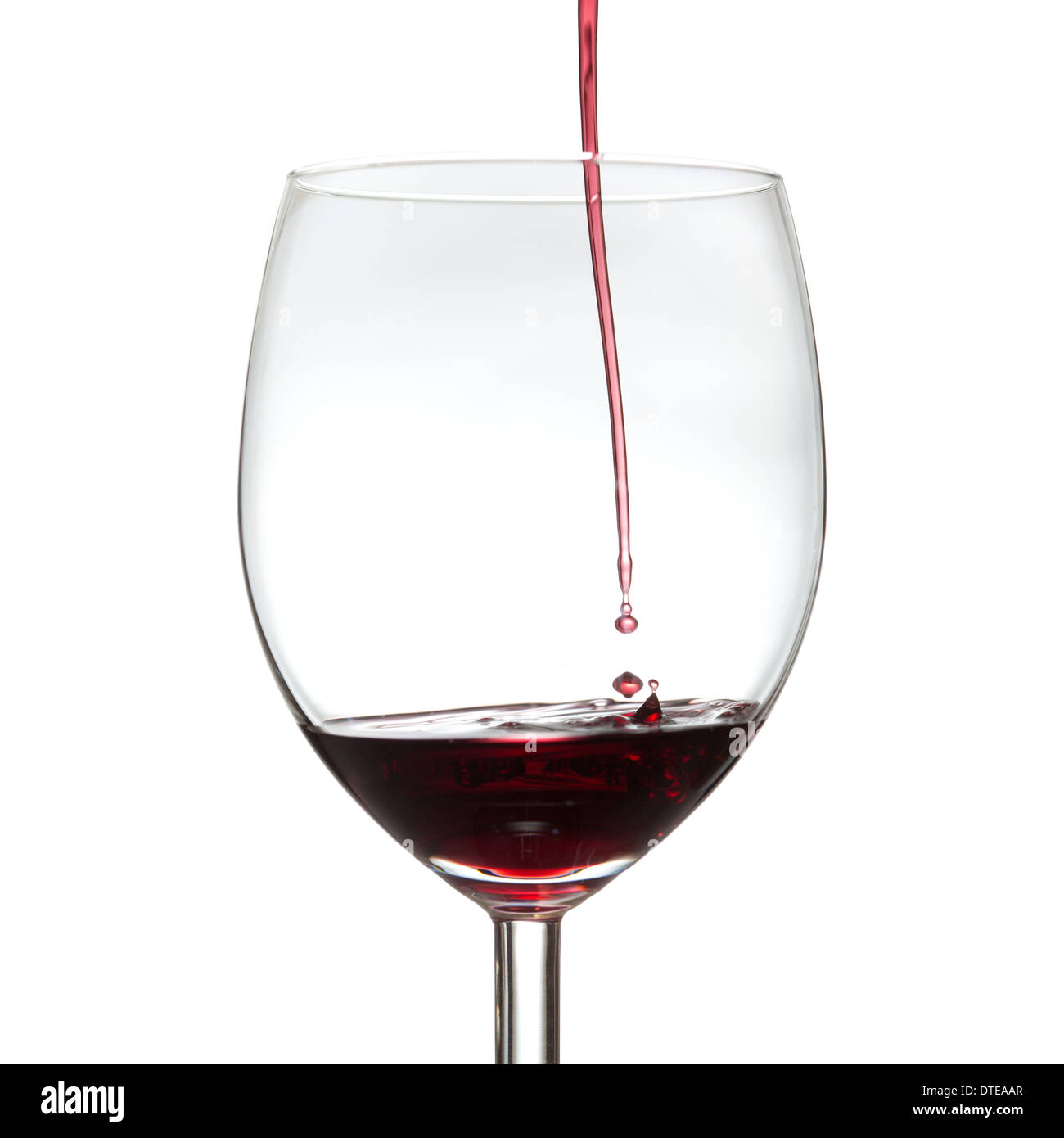 drops of red wine falling into wine glass Stock Photo Alamy
