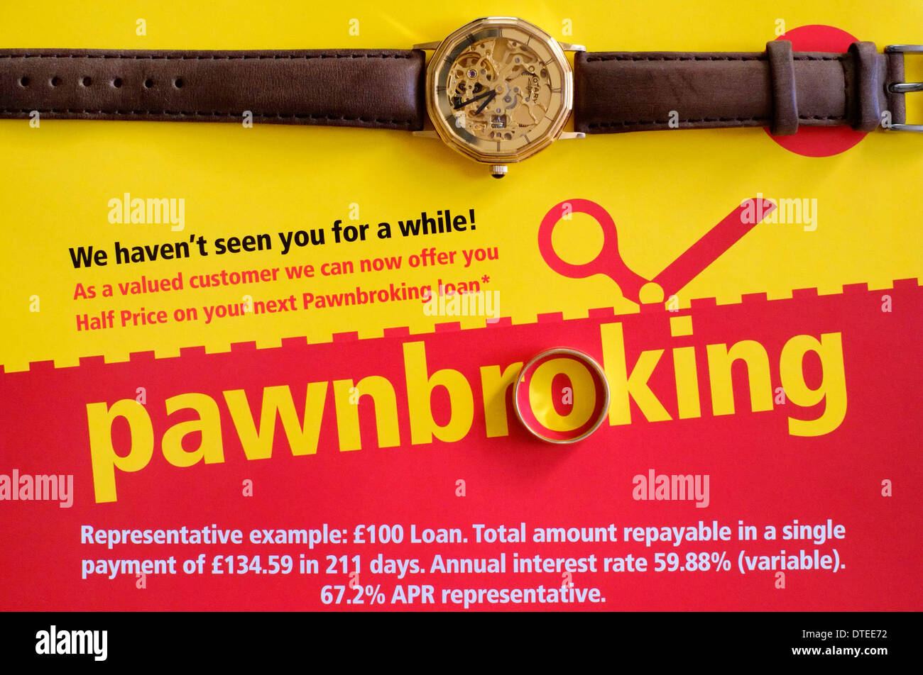 a gold watch and ring laying on top of a leaflet for a pawnbrokers