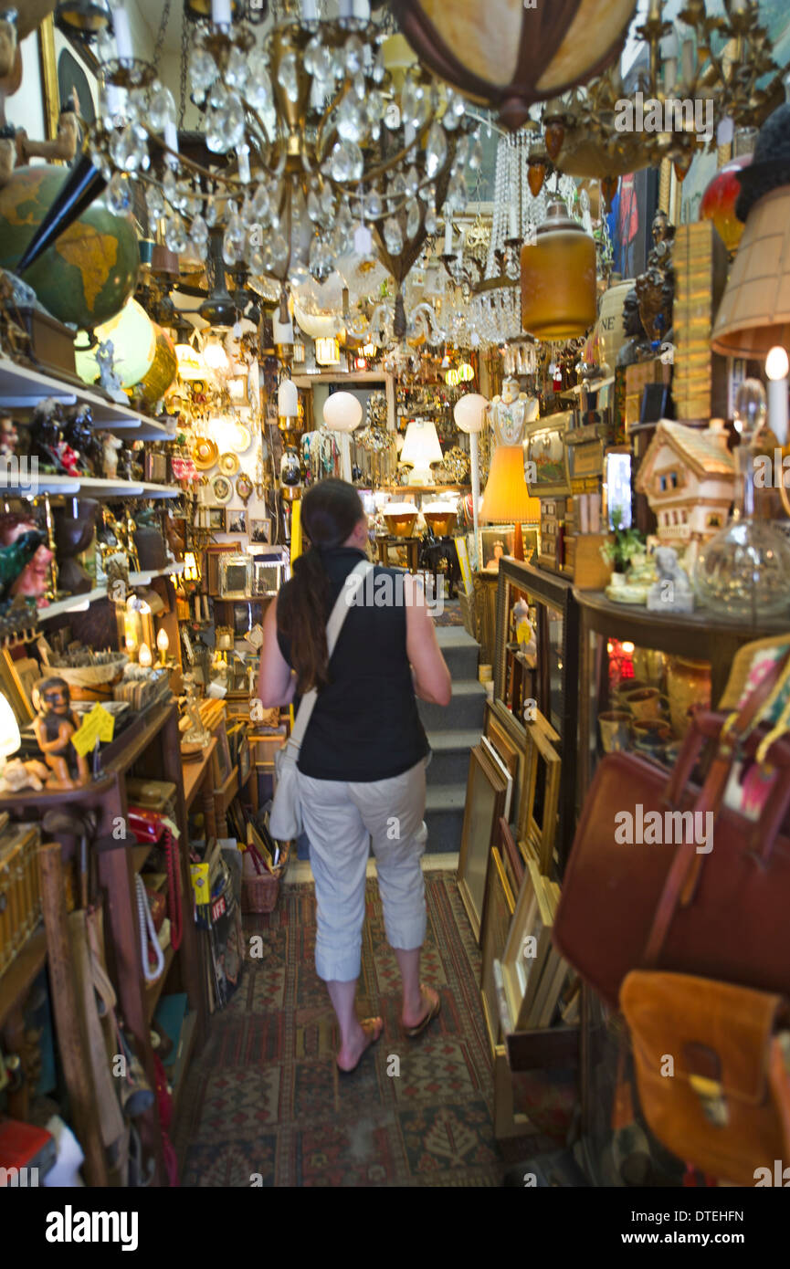 Visitor exploring overstuffed shelves of an antique store in Toronto