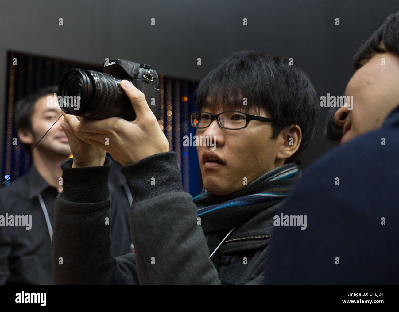 Yokohama, Japan. 17th Feb, 2014. A photo taken on February 14, 2014 shows a visitor trying out the Panasonic Lumix GH4 camera during the 2014 Camera and Imaging Show (CP ). CP  exhibited the latest photography and video equipment attracting thousands of visitors over a four day period from February 13-16. © AFLO/Alamy Live News Stock Photo