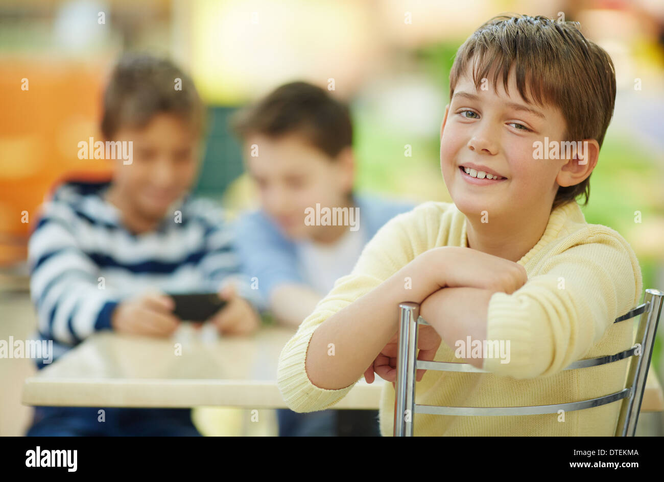 Boy smiling at camera in cafe Stock Photo