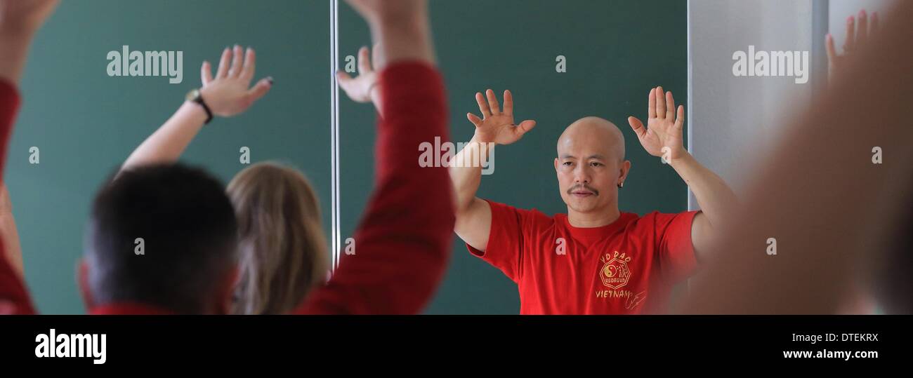 Aschersleben, Germany. 12th Feb, 2014. Kung Fu Grandmaster Chu Tan Cuong teaches policemen at the police school in Aschersleben, Germany, 12 February 2014. Officials are educated in breathing techniques for stress and conflict management. Photo: Jens Wolf/dpa/Alamy Live News Stock Photo