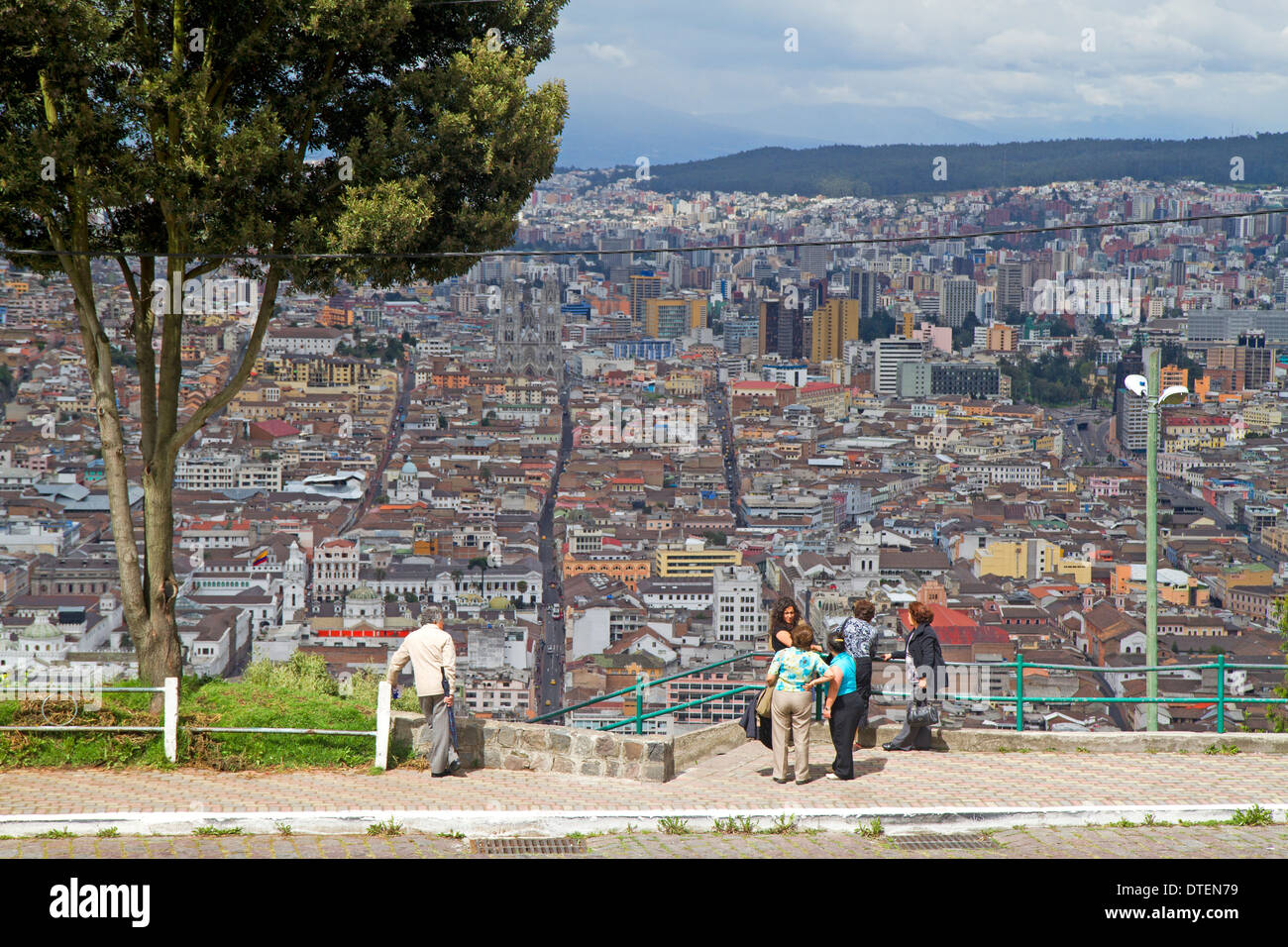 Visitors taking in the view over Quito from El Panecillo hill Stock Photo