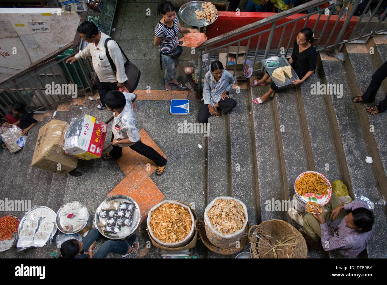 Food vendors are selling food on a stairway inside the Russian Market in Phnom Penh, Cambodia. Stock Photo