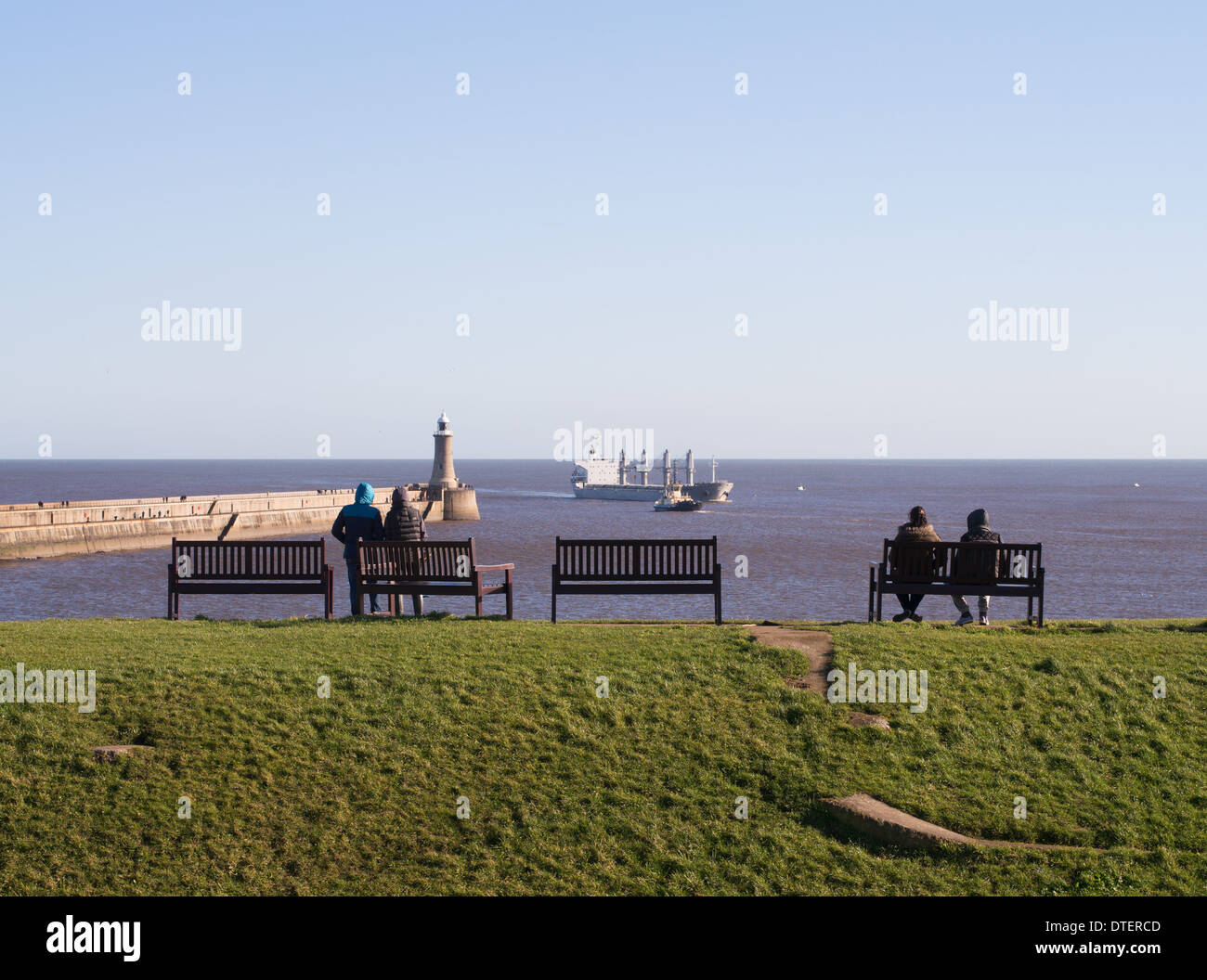 People watching ship entering the river Tyne at Tynemouth north east England UK Stock Photo