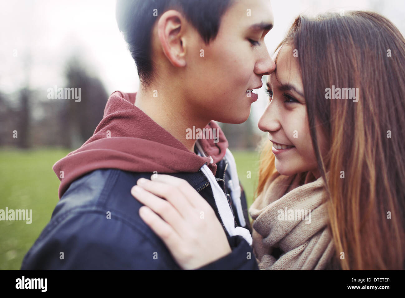 Close up image of cute young couple in love together in park. Asian teenage couple spending romantic time with each other. Stock Photo