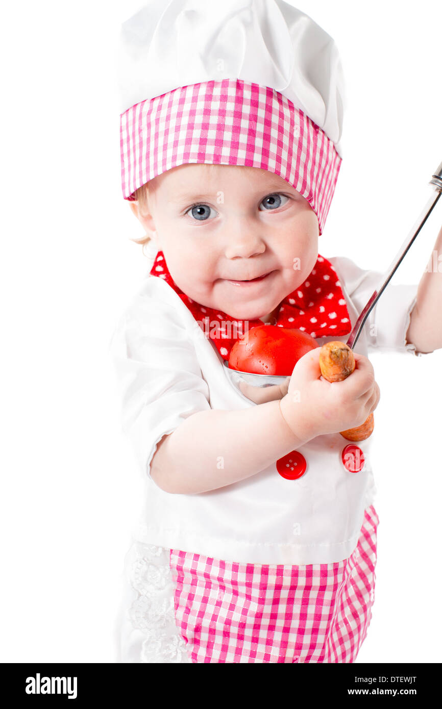 Baby cook girl wearing chef hat with fresh vegetables and fruits. Use it for a child, healthy