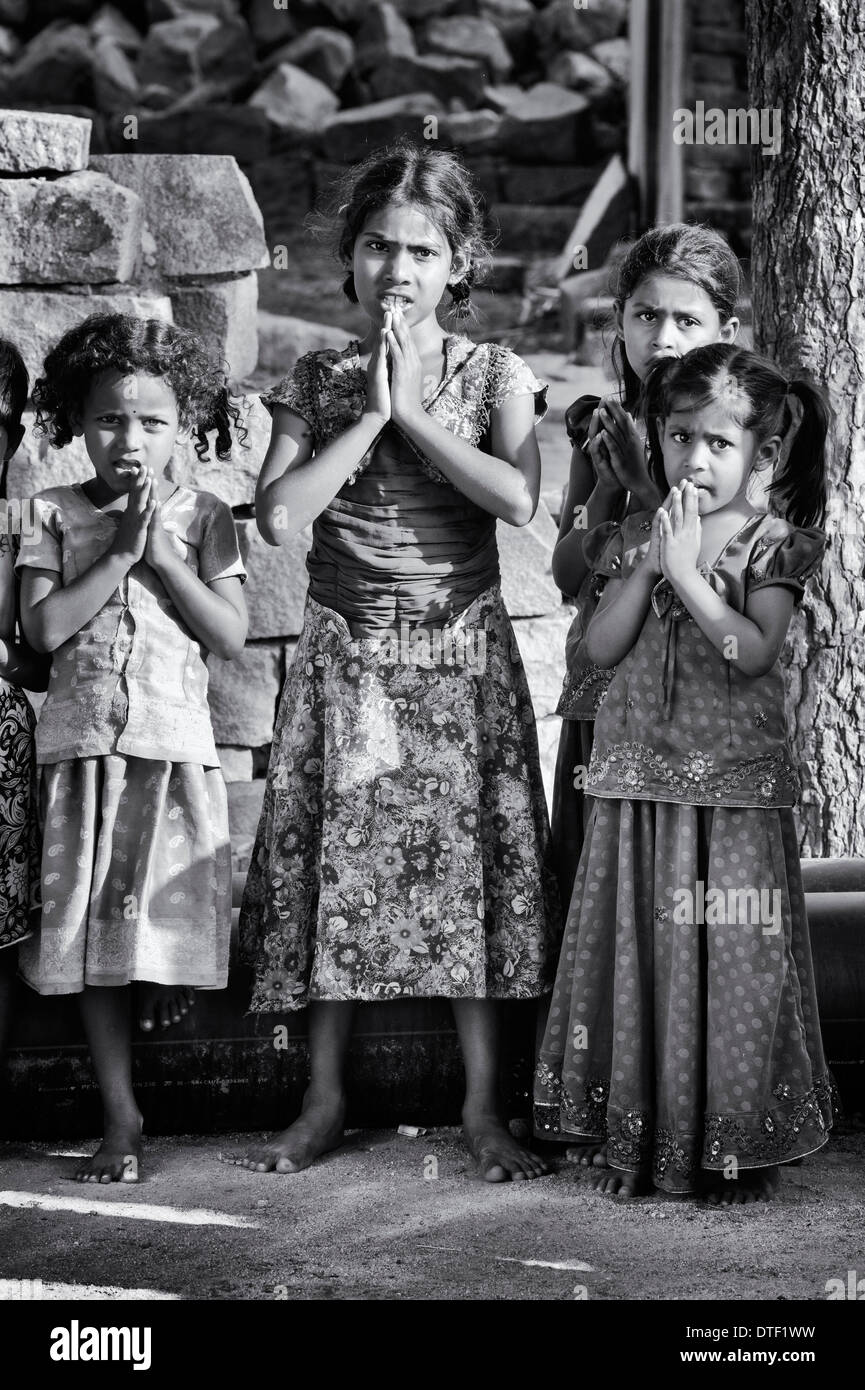 Rural Indian village school girls offering namasker. Andhra Pradesh, India. Monochrome Stock Photo