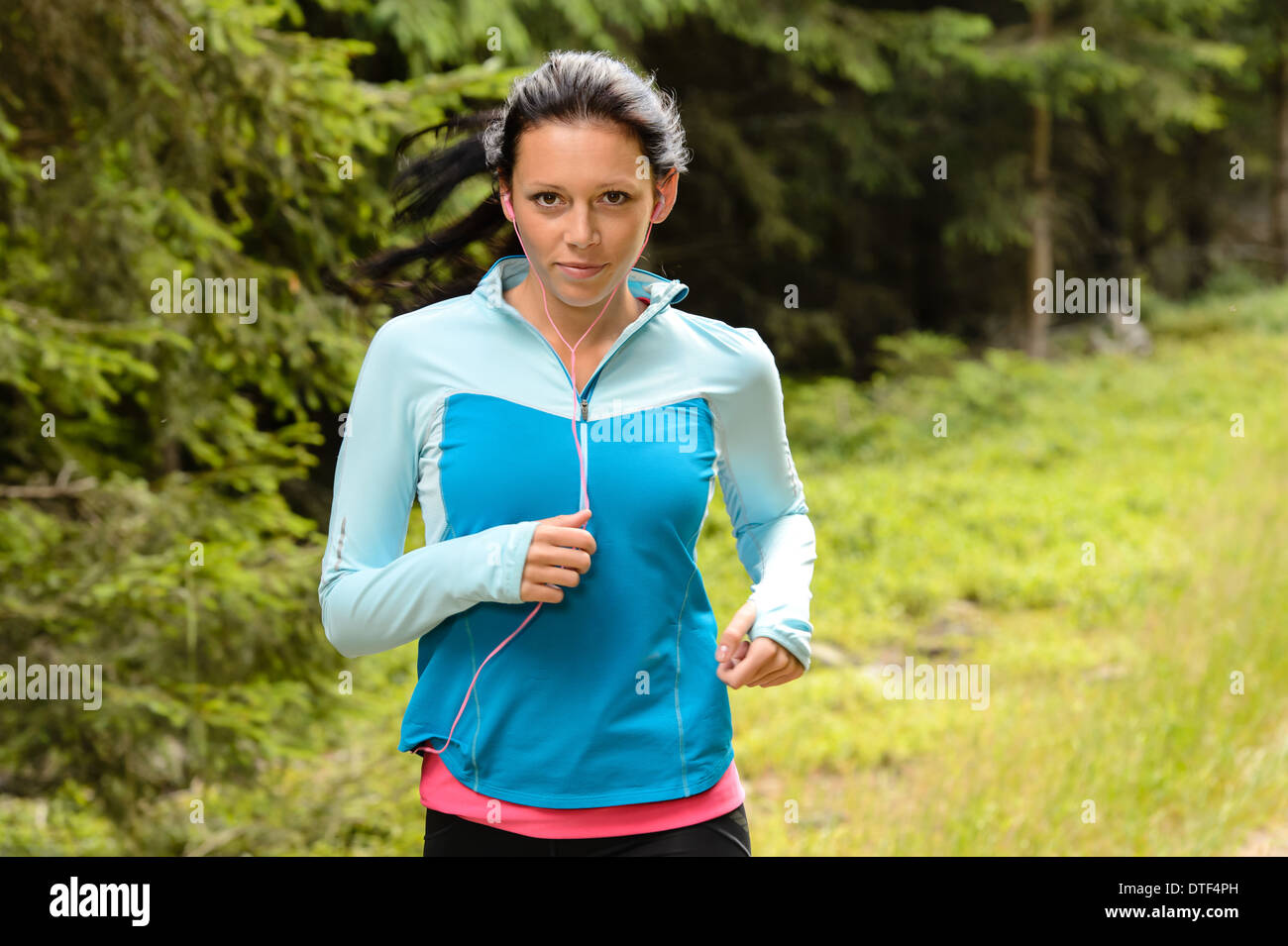 Running woman in forest fitness training outdoor Stock Photo