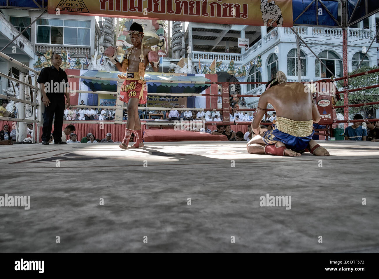 Muay Thai kick boxers performing pre-fight ritual of respect, guidance and safe keeping. Thailand S. E. Asia Stock Photo