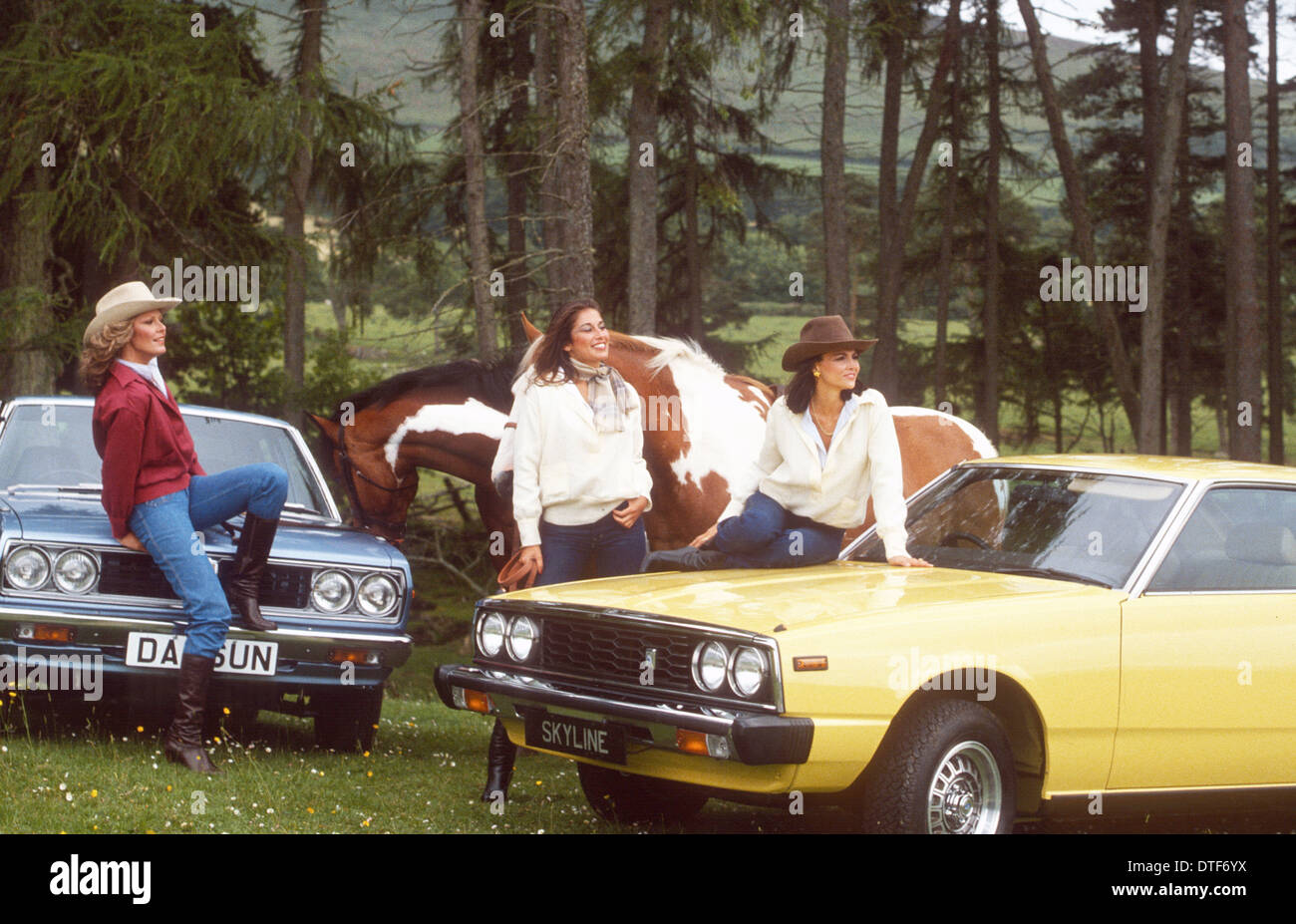 THREE MODELS DRESSED WESTERN STYLE FOR A CAR ADVERTISMENT Stock Photo