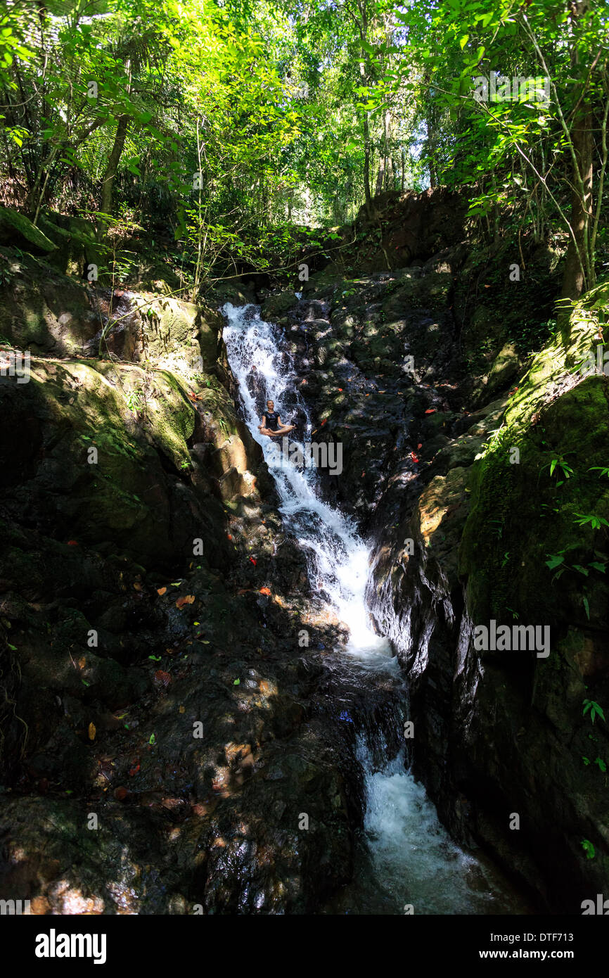 Young woman enjoying in yoga pose in Waterfall Stock Photo - Alamy