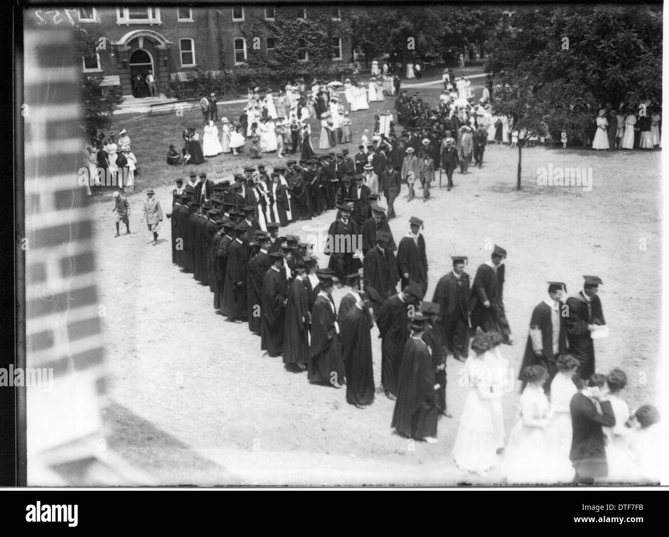 A photograph showing a procession forming during the 1912 commencement ...