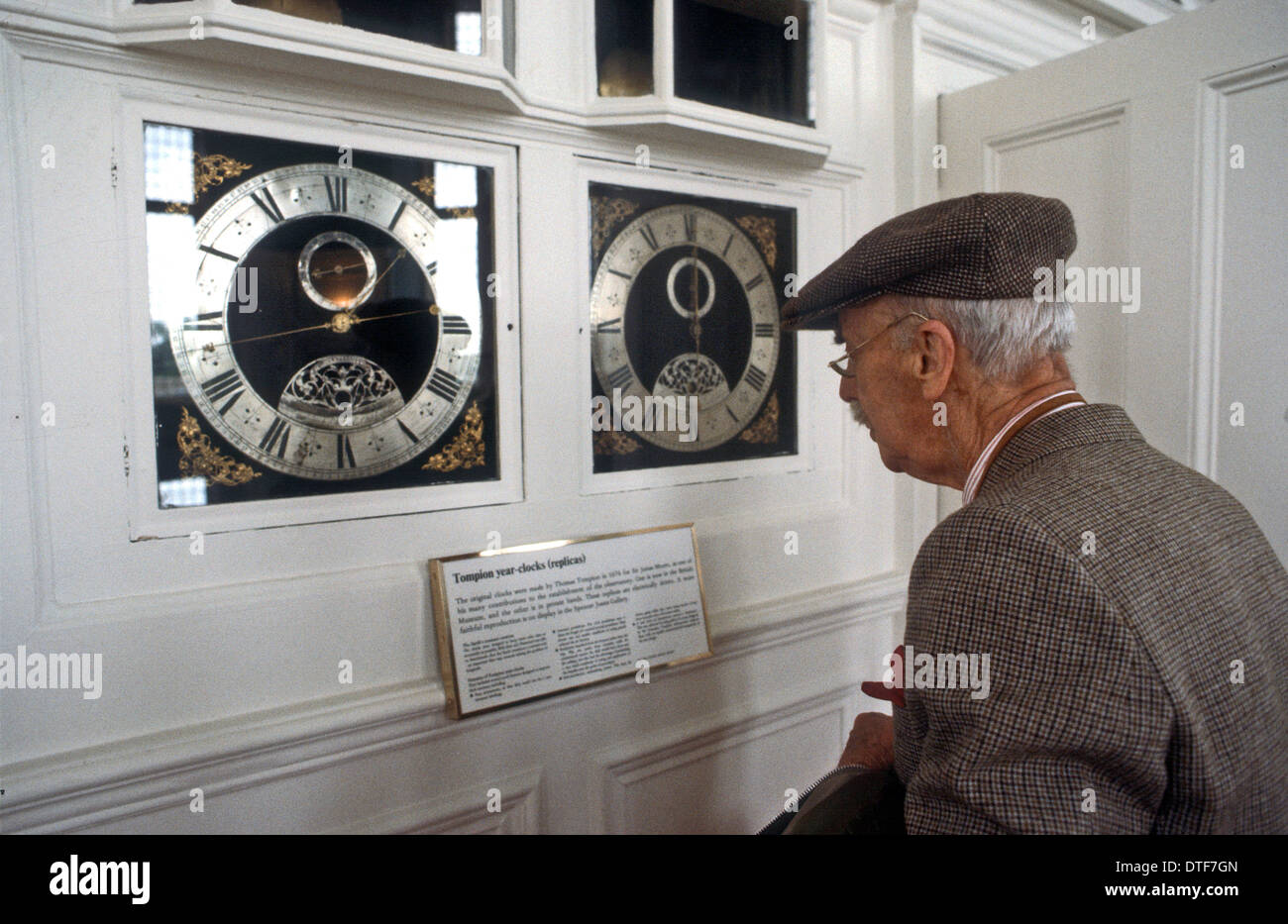 Greenwich Observatory  Londin UK. An eldery man examines the Tampion Year Clocks Stock Photo