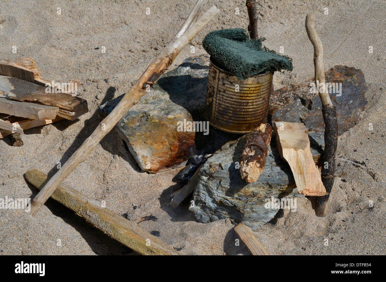 Survival skills concept - water distillation on a shoreline. Behind enemy lines concept. World Water Day concept. Stock Photo