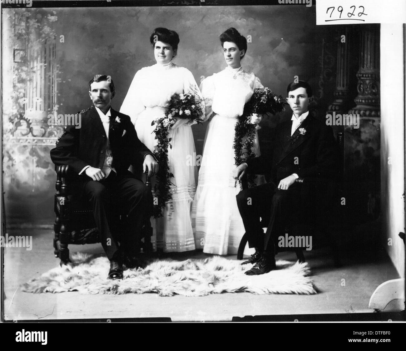 This photograph captures a bridal party in 1907, featuring individuals ...