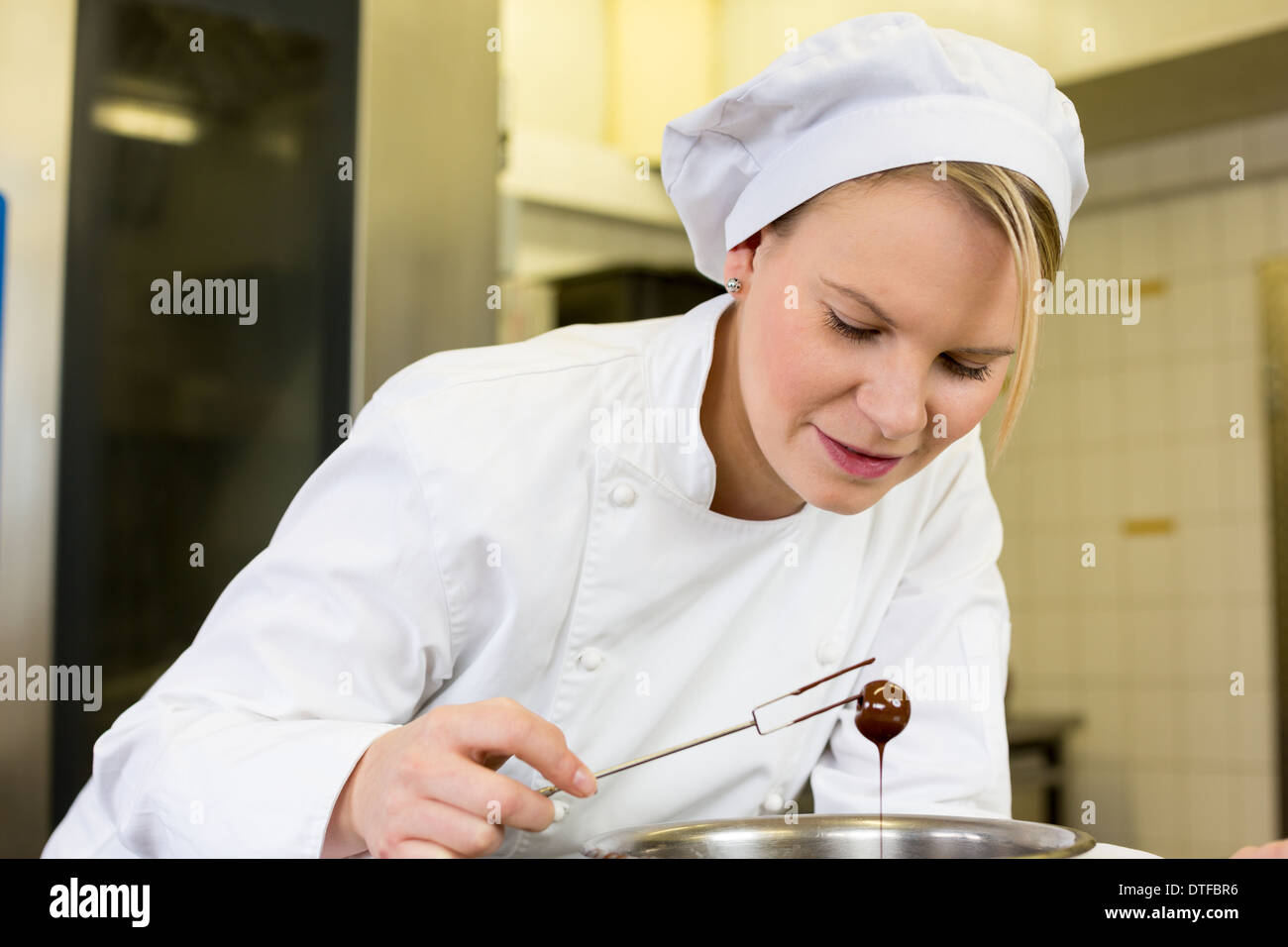 confectioner producing filled chocolates in confectionery Stock Photo