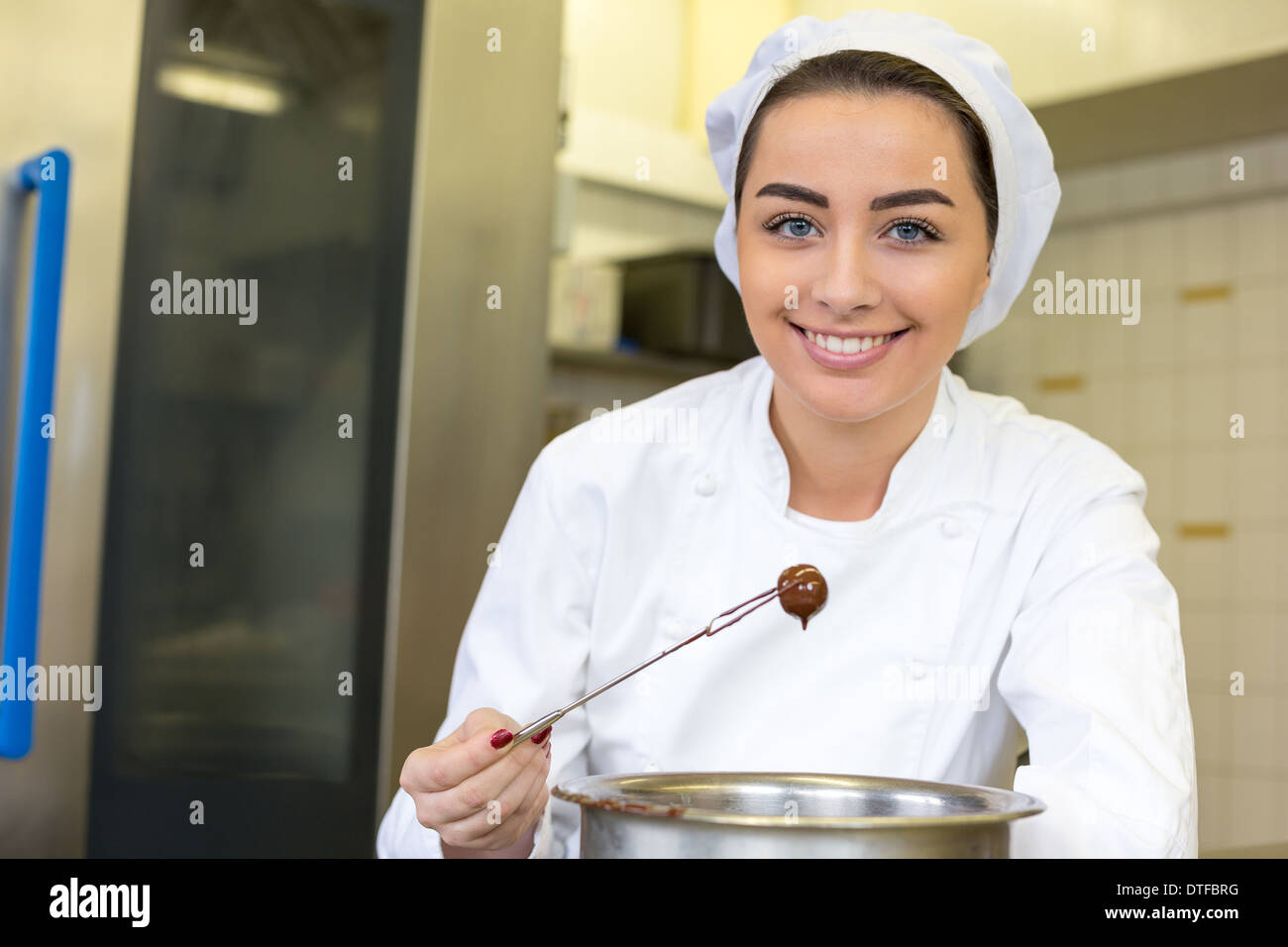 confectioner producing filled chocolates in confectionery Stock Photo